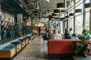 a restaurant with people sitting at tables at The Social Hub Rotterdam in Rotterdam