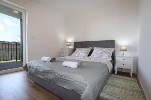 a bedroom with a bed with two towels on it at Apolo Apartments - Pool & Garden Retreat in Pula +118 photos