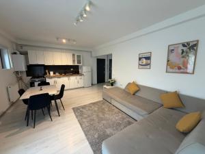 a living room with a couch and a table at Otopeni Studio C2 3 Airport Therme in Otopeni