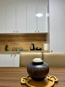 a vase sitting on a table in a kitchen at Central apartment 3 in Gnjilane