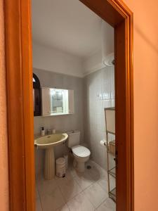 a bathroom with a toilet and a sink at ElRodia Sea View in Kipséli +9 photos