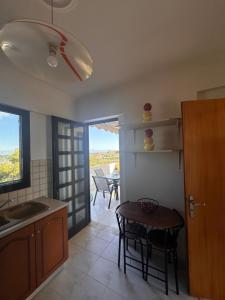 a kitchen with a table and a dining room with a view at ElRodia Sea View in Kipséli