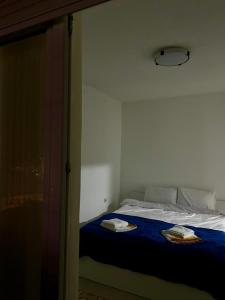 a bedroom with a bed with two towels on it at Central apartment 3 in Gnjilane