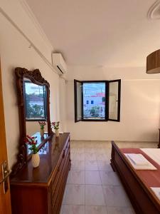 a bathroom with a vanity and a mirror and a sink at ElRodia Sea View in Kipséli