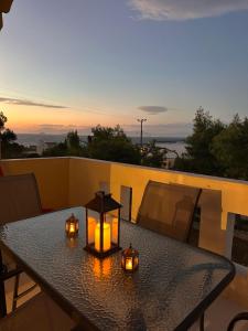 a table on a balcony with candles on it at ElRodia Sea View in Kipséli