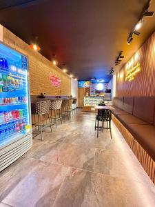a restaurant with a bar with chairs and a counter at Hotel Nakama in Medellín
