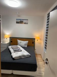 a bedroom with a bed with a black and white blanket at Ferienwohnung Florion 2 in Bernburg