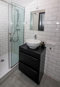 a bathroom with a sink and a glass shower at Mia Mia House in Katowice +50 photos