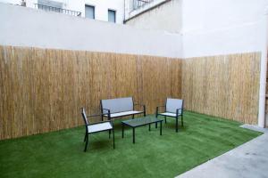 a group of chairs and a table on the grass at Can Turia in Valencia