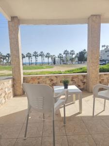 a table and chairs on a patio with a view at 2 bedroom home sea view in Pyla