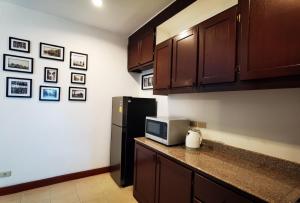 a kitchen with a black refrigerator and a counter top at Trivista Khaoyai in Ban Khanong Phra Klang (1)