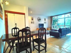 a living room with a dining room table and chairs at Trivista Khaoyai in Ban Khanong Phra Klang (1)