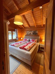 a bedroom with a bed in a wooden room at Blockhaus Bayerischer Wald in Stamsried
