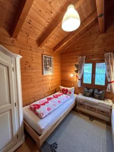 a bedroom with a bed in a log cabin at Blockhaus Bayerischer Wald in Stamsried +18 photos