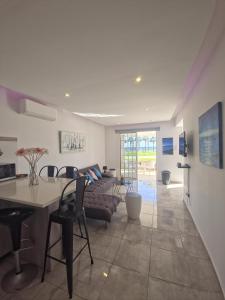 a kitchen and living room with a table and chairs at 2 bedroom home sea view in Pyla