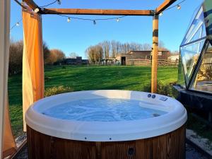 a jacuzzi tub in the backyard of a house at Dôme Saint-Eloi in Floursies