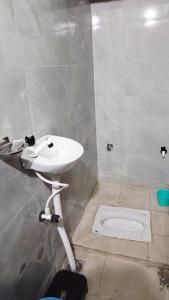 a bathroom with a sink and a toilet at Radha Rani Guest House in Sīkar