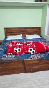 a bedspread with soccer balls on top of it at Radha Rani Guest House in Sīkar