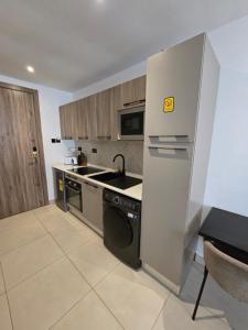 a kitchen with a stainless steel refrigerator and a dishwasher at Belrose Place in Accra