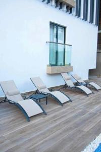 a group of chairs and a table in a room at Belrose Place in Accra