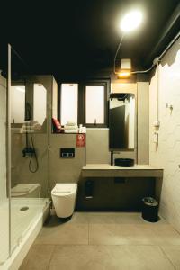 a bathroom with a toilet and a sink and a shower at LOFT Hotel by Sommelier Hoteles in Santiago +22 photos