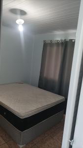 a bedroom with a bed in a room at Casa simples e arejada in Caxias do Sul