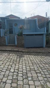 a blue building with a bench in front of it at Casa simples e arejada in Caxias do Sul