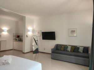 a living room with a couch and a flat screen tv at CconfortHotels Sea Dream Palace in Trani
