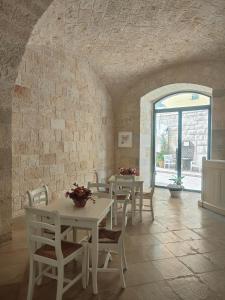 a room with white tables and chairs and a window at CconfortHotels Sea Dream Palace in Trani