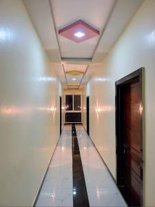 a hallway in a building with a ceiling at Hotel Suraj Palace And Restaurant in Rūpaheli