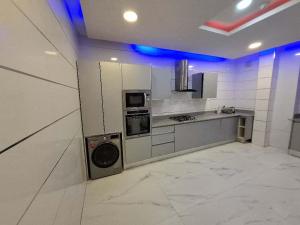 a large kitchen with a stove and a microwave at Presken Apartment Ikoyi in Lagos +15 photos