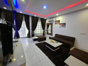 a living room with a couch and a table at Presken Apartment Ikoyi in Lagos