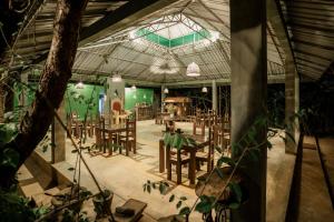a dining room with tables and chairs in a building at Vihanga Village - Jungle retreat in Dambulla in Dambulla +42 photos
