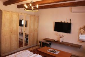 a living room with a tv on the wall at Apartments Kenan in Plav