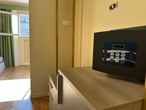a room with a tv on top of a counter at Boboli Living in Florence +39 photos