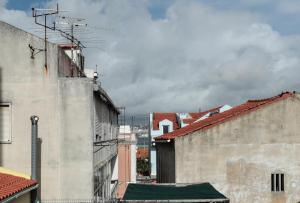 an alleyway between two buildings with roofs at Republica House in Trafaria