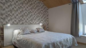 a bedroom with a bed with two pillows on it at La Belle Noue in Bellenod-sur-Seine