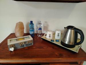 a table with a tea kettle and other items on it at La maison d'amour in Sanluri