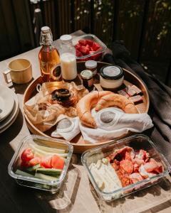 a table with a tray of food and plates of food at Mókuslak Mátra in Mátraszentimre