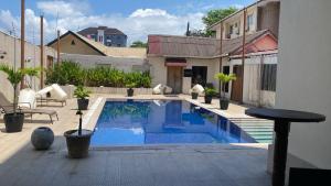 a swimming pool in the middle of a house at Bella Casa Hotel in Monrovia