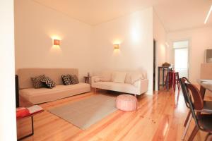 a living room with a couch and a chair at Republica House in Trafaria