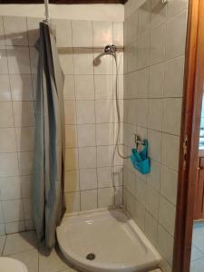 a shower in a tiled bathroom with a toilet at La maison d'amour in Sanluri +7 photos