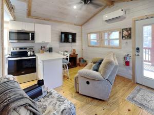 a living room with a couch and a kitchen at Caney Creek in Jenkins Mill