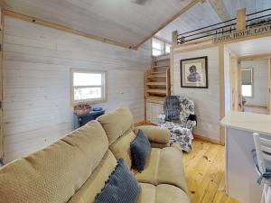 a living room with a couch and a table at Caney Creek in Jenkins Mill