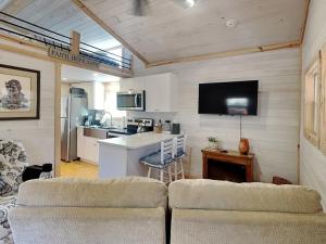 a living room with two chairs and a kitchen at Caney Creek in Jenkins Mill +19 photos