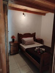 a bedroom with a bed with a stuffed animal on it at La maison d'amour in Sanluri