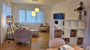 a living room with a couch and a table at Swiss Lakeside Apartments in Spiez