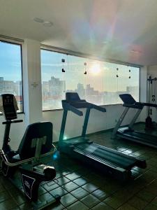 a gym with two exercise bikes and a window at Flat Próximo Shopping Santa Úrsula in Ribeirão Preto