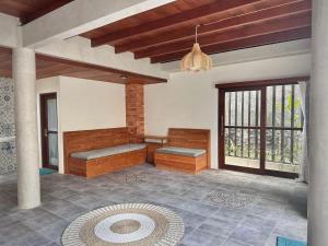 a living room with benches and a pendant light at Casa Loka in Canggu