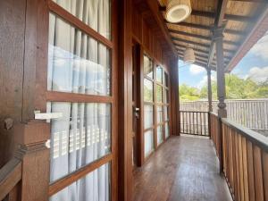 a wooden hallway with a door and a balcony at Casa Loka in Canggu